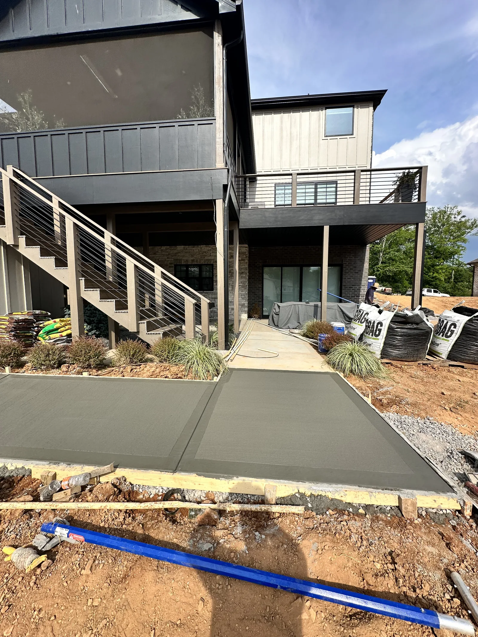 Concrete walkway installation modern home Knoxville TN — landscape around you